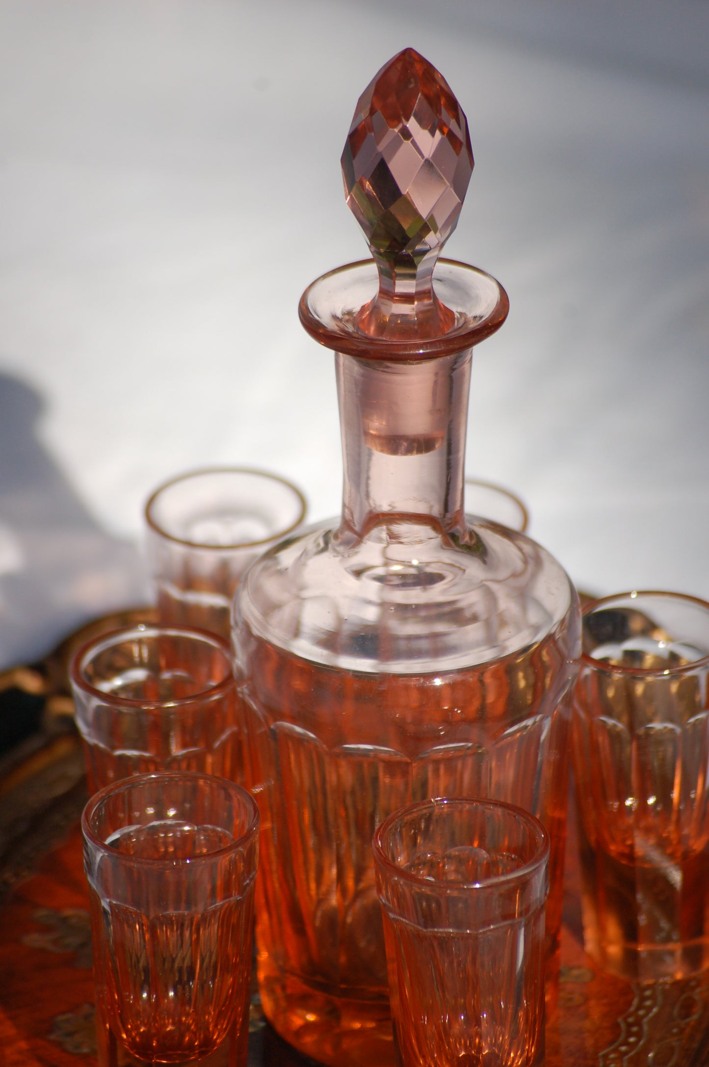 ©mediterrastyle A gorgeous little vintage liquor set from Italy. A beautiful designed bottle with 5 little liquor glasses. Perfect for digestivo or amaro, the rose glass just feels like something from another era. Mid Century. In Sicily they would serve Rosolio, a sweet liquorous wine at the end of a meal while leaning back on a wicker chair upon a sunny terrace. You can just hear the cicadas in the background. Loved and sold by MediterraStyle